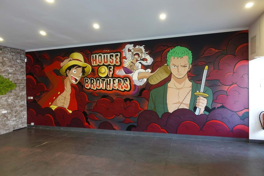 Auftrags-Graffiti im Fast-Food-Restaurant House of Brothers in Bremen, inspiriert von der Anime-Serie One Piece, mit lebhaften Charakteren und roten Wolken im Hintergrund.