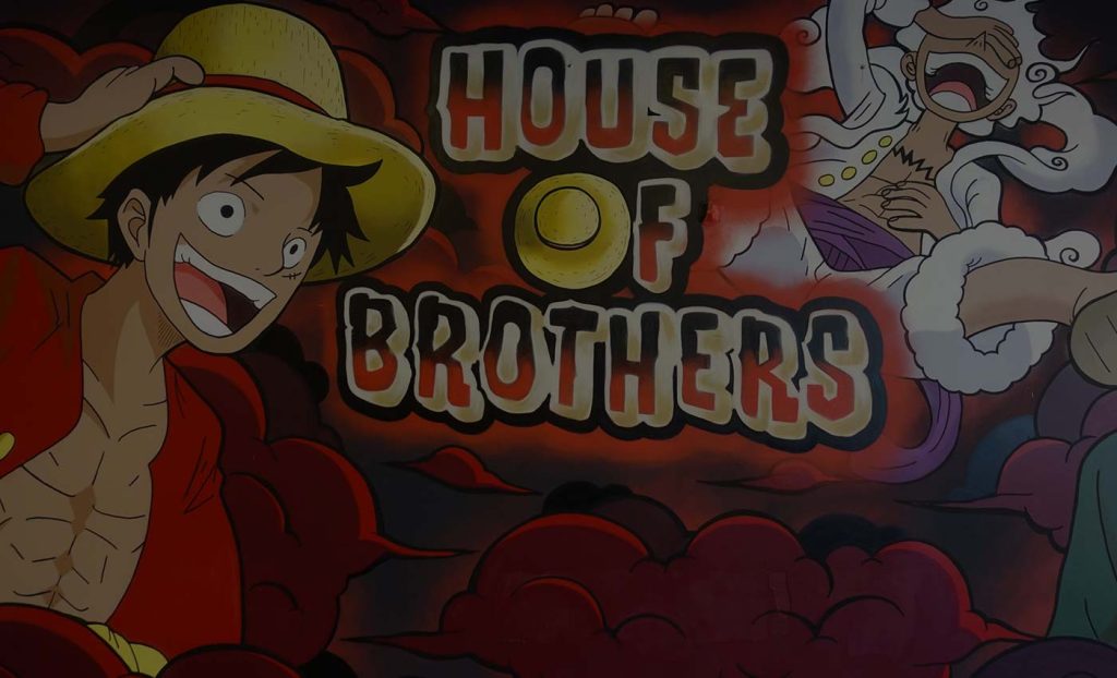 Auftrags-Graffiti im Fast-Food-Restaurant House of Brothers in Bremen, inspiriert von der Anime-Serie One Piece, mit lebhaften Charakteren und roten Wolken im Hintergrund.